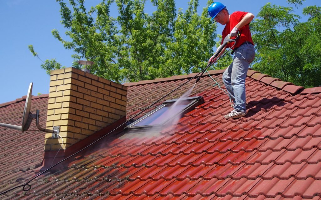 Professional roof cleaning service being performed on a residential property in London